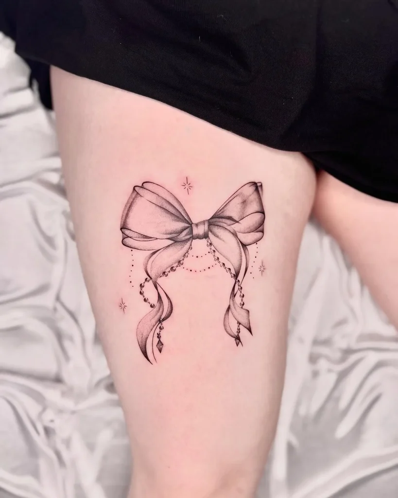 ### Elegant Thigh Bow Tattoo